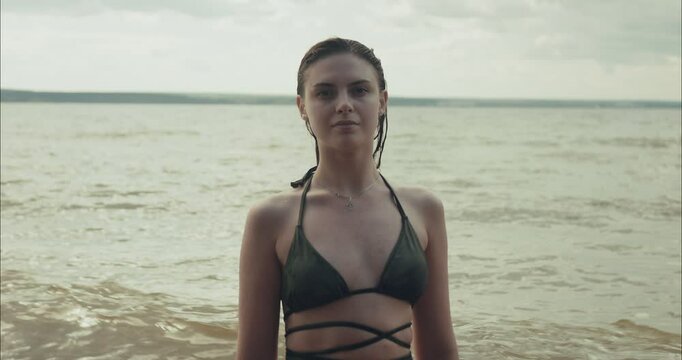 Young model posing in water at the beach