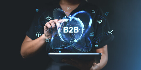 Business professional interacting with B2B digital icons on a ta