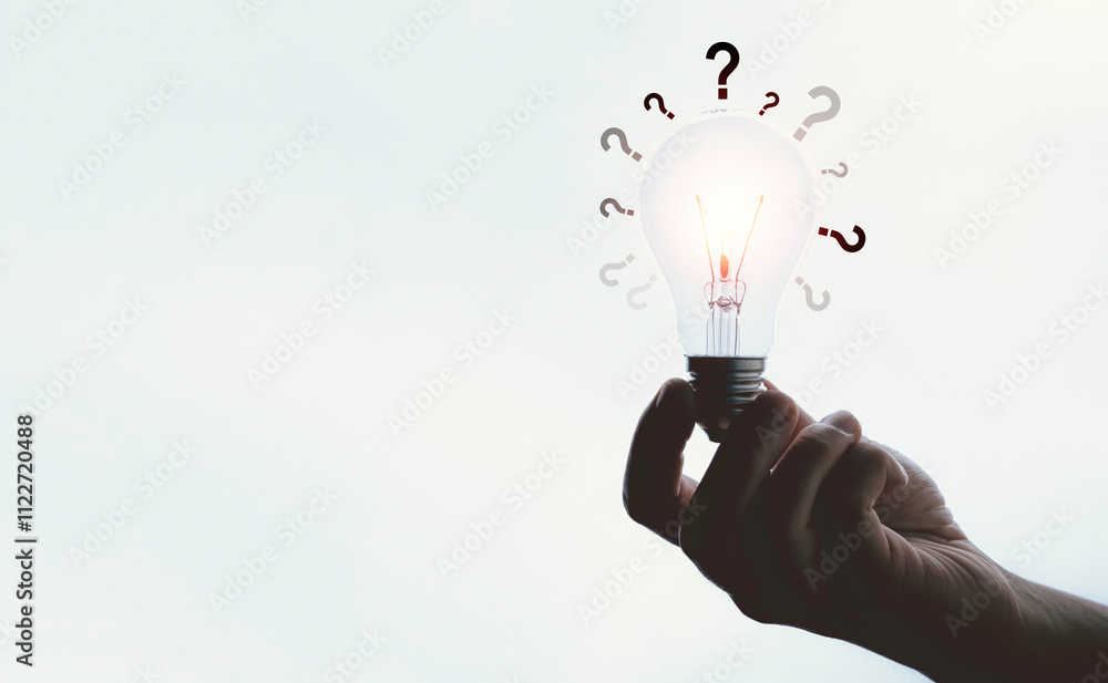 Poster hand holding glowing lightbulb with question mark and copy space for creative thinking and problem s