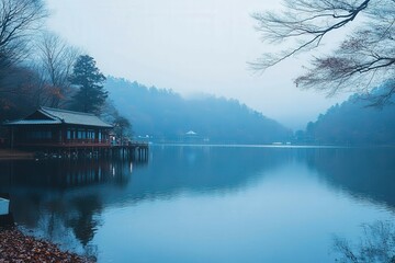 Fototapeta premium Tranquil Lake Scene in Misty Atmosphere
