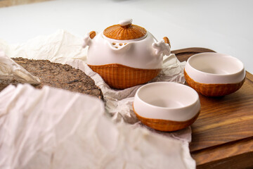 Tea set for making and drinking  on a white background. Teapot and cups, pressed black tea. Tea...