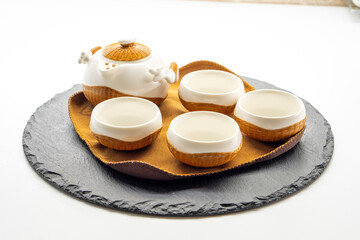 Tea set for making and drinking  on a white background. Teapot and cups, pressed black tea. Tea...