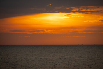 Obraz premium A serene seascape with a distant island silhouetted against the twilight sky
