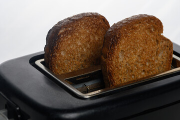 Toasting bread to golden perfection in modern kitchen at breakfast time