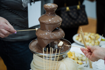 Indulge in a delightful experience with a mouthwatering chocolate fountain at a festive gathering,...