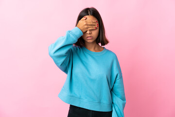 Young latin woman isolated on pink background covering eyes by hands. Do not want to see something