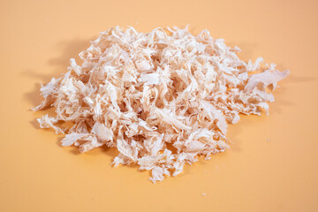 Close-up of wood shavings, with a detailed texture and natural lighting