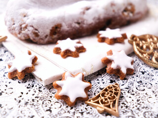 Christmas strudel with marzipan and cinnamon stars on bright background. Close up.