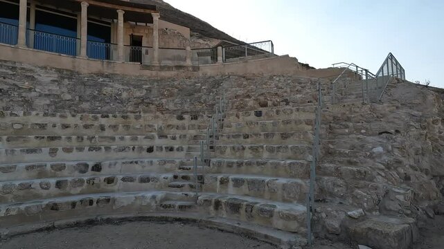 A clear, sunny day reveals the small amphitheater ruins at Herodium, an ancient site of historical and archaeological significance in Israel, offering a glimpse into the past.