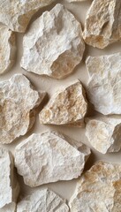 A close-up view of rough, light-colored stones arranged on a surface.