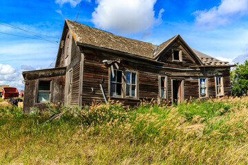 A large, old house with a lot of windows and a lot of grass in front of it