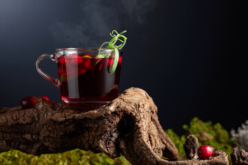 Hot drink with cranberries, lime, and rosemary.