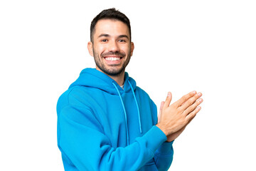 Young handsome caucasian man over isolated chroma key background applauding