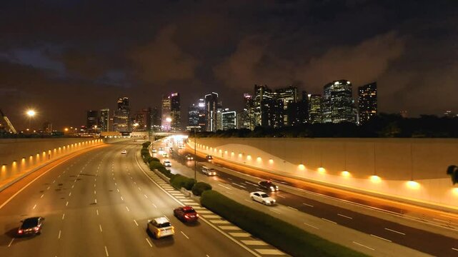 Night Scene of Downtown Singapore with Traffic Car City Timelapse. The Marina Coastal Expressway (MCE) is a key underground expressway in Singapore, spanning approximately 5 kilometres.