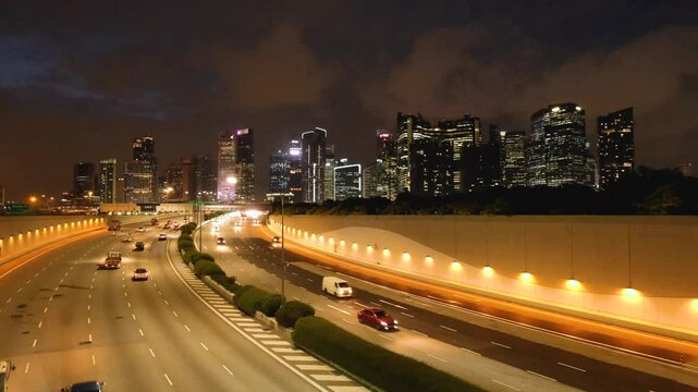 Night Scene of Downtown Singapore with Traffic Car City Timelapse. The Marina Coastal Expressway (MCE) is a key underground expressway in Singapore, spanning approximately 5 kilometres.