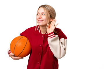 Young hispanic woman playing basketball over isolated white background listening to something by putting hand on the ear