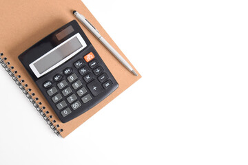 Calculator and office supplies on white table. Top view with copy space.