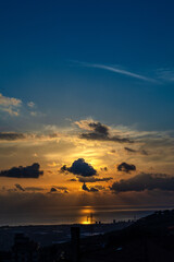 Scenery sun sunset behind the clouds