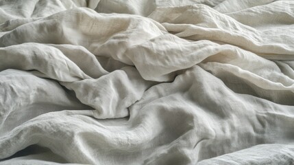 A close-up of crumpled white fabric, showcasing its texture and softness.