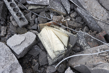 An open Arabic book rests among rubble and ashes. Represents resilience, loss, cultural heritage, the impact of war, or the fragility of knowledge amidst destruction.