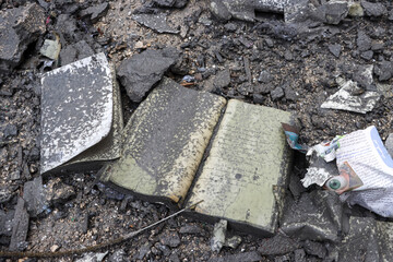 An open Arabic book rests among rubble and ashes. Represents resilience, loss, cultural heritage, the impact of war, or the fragility of knowledge amidst destruction.