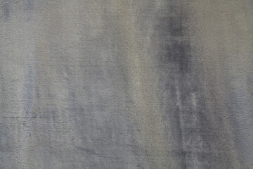 An old and shabby surface, background of dence knitted fabrics. Backdrop of wicker fiber, thick tarpaulin. Texture of fabric coating (covering) of ancient, faden tarpaulin. Grey waterproof canopy