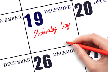 December 19. Hand writing text Underdog Day on calendar date. Save the date.