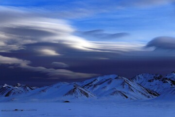 winter mountain landscape. Magical clouds in the mountains of Kyrgyzstan.
