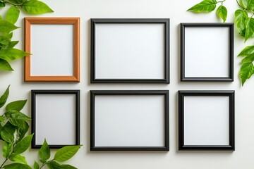 An arrangement of six empty picture frames in various sizes surrounded by vibrant green leaves, creating a fresh and modern decorative display. trending mockup design