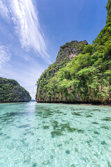 Stunning view of Phi Phi Island in Thailand, featuring crystal-clear turquoise water, white sandy beach. This tropical paradise is a world-famous travel destination known for its scenic cliffs.
