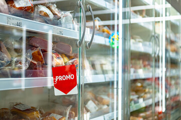 Promo sign at a commercial refrigerator in a supermarket