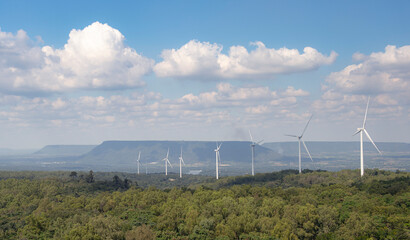 A windmill power farm in the northeast of Thailand, featuring large wind turbines spinning in the open landscape. This image highlights renewable energy, clean power generation