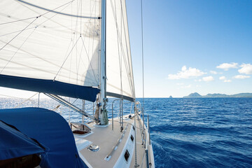 Beautiful charter sailing yacht sailing in the Caribbean with full sails up on a beautiful sunny day