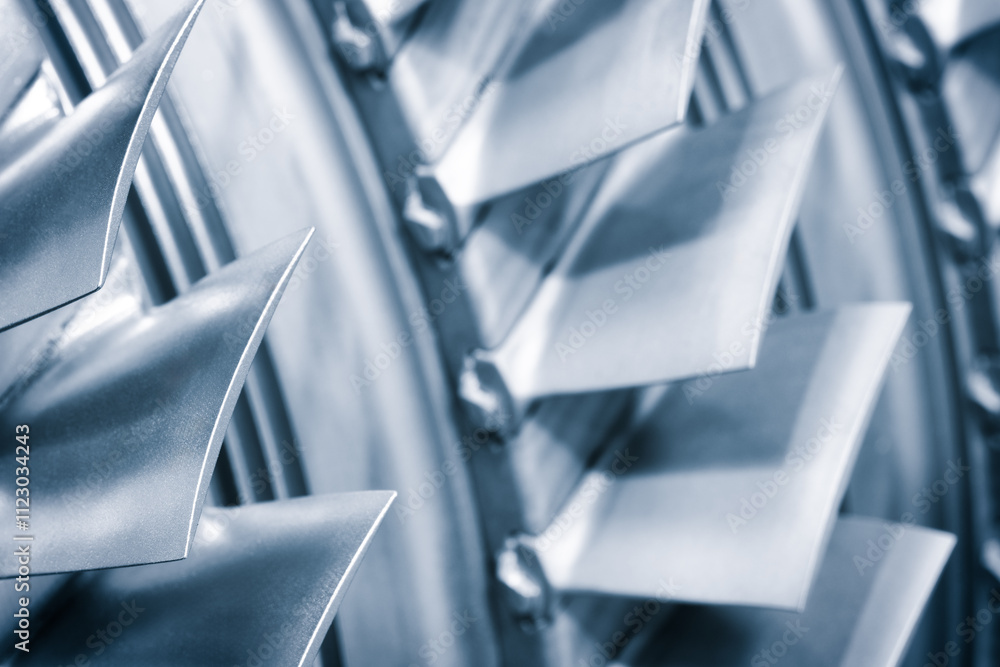 Aufkleber A close up of a turbine with many blades. The blades are silver and are angled at different angles