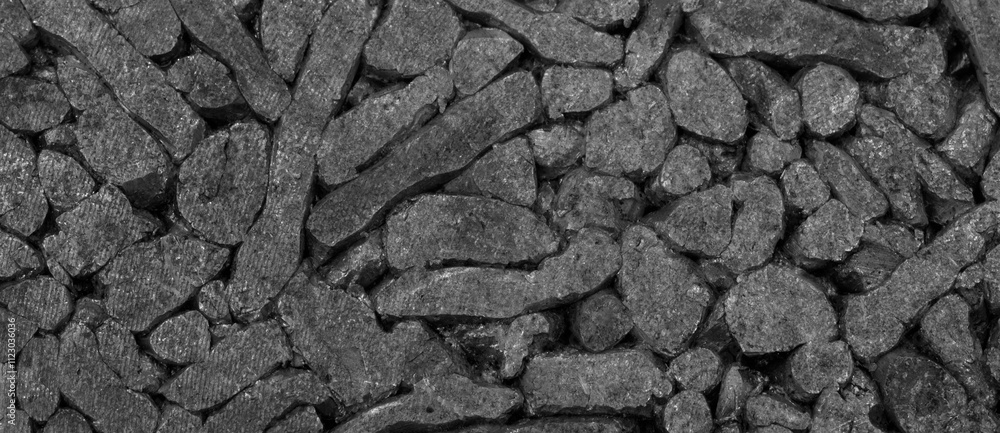 Aufkleber A pile of black rocks. The rocks are small and are scattered all over the ground. The pile is made up of many different sized rocks black background
