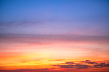 Naklejka premium Sky,sunset, beautiful , luxury soft gradient orange gold clouds and sunlight on the blue sky perfect for the background, Sunrise on morning or evening in winter warm time ,Twilight summer,silhouette