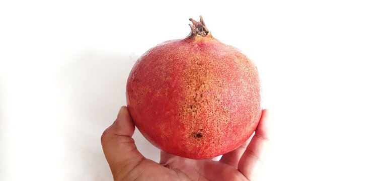 Fresh Pomegranate fruit or buah delima isolated on white background