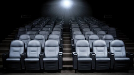 Obraz premium Empty movie theater with spotlight casting a solitary beam on the stage, symbolizing the power of imagination and the potential for new beginnings in a quiet, reflective space.