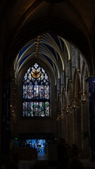 Obraz premium Stained glass window illuminating dark church interior in scotland