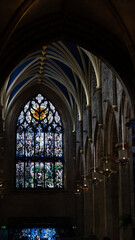 Obraz premium Stained glass window illuminating the dark interior of a church in scotland