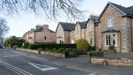 Traditional stone houses line a quiet street in scotland