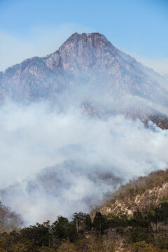 Bushfire smoke from a wildfire surrounds Mt Barney in the Scenic Rim.