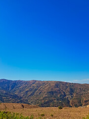 Naklejka premium Serene Rustic Mountain Landscape on a Sunny Day