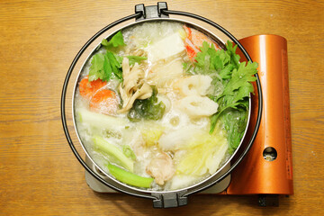 Vegetables, seafood, meat and mushrooms cooked in a pot, popular in winter in Japan and other Asian countries.