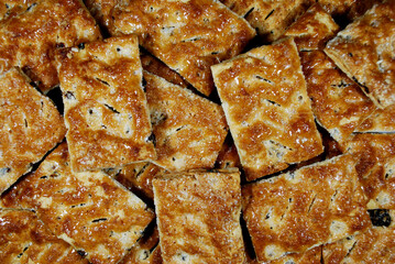 Puff pastry cakes with raisins and sugar lie on the surface