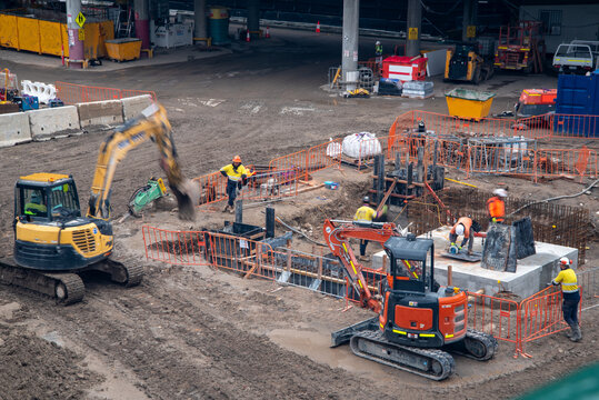 Construction site with machinery and workers in high-vis