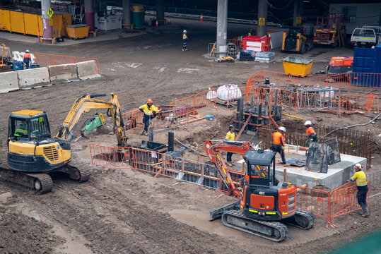 Construction site with machinery and workers in high-vis