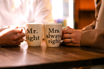 Couple enjoying coffee in Melbourne laneway with 'Mr Right' and 'Mrs Always Right' mugs