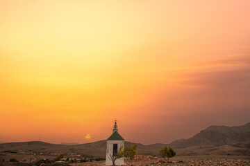 small cute white wooden chapel in a barren volcanic landscape. Sunrise, landscape shot of Ermita...
