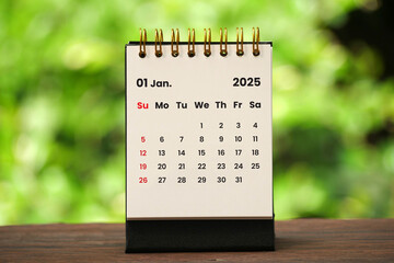 January 2025 - A small desktop calendar for January 2025 with nature background, time and business concept.